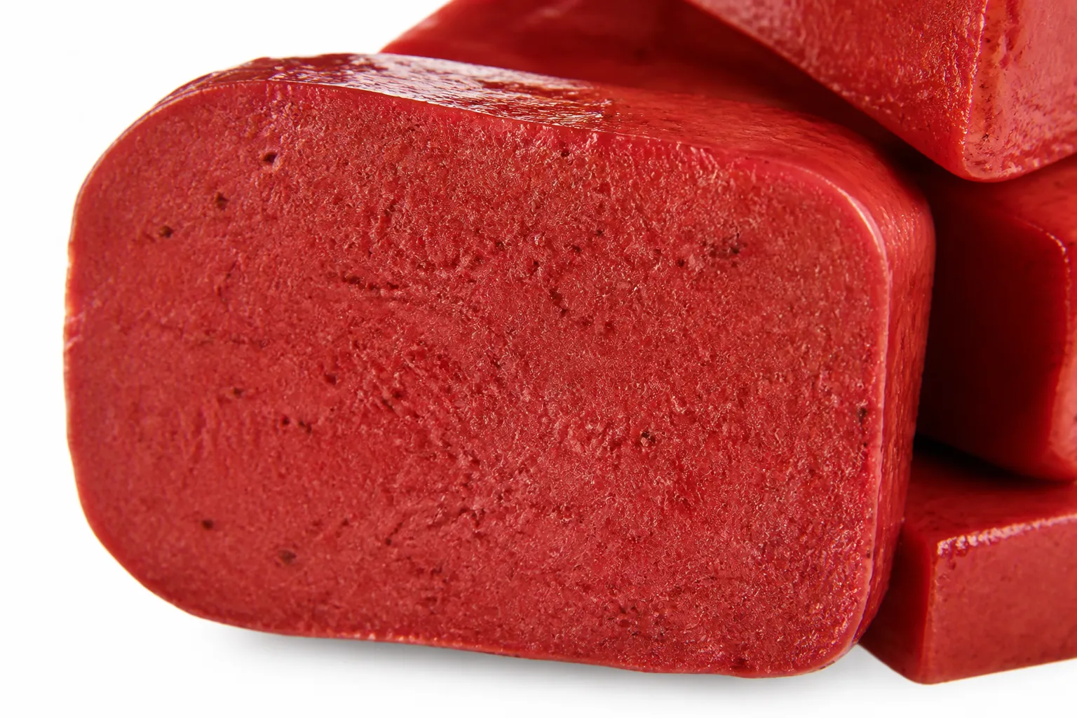 Close-up of a cut face of red konjac showing the colour running all the way through