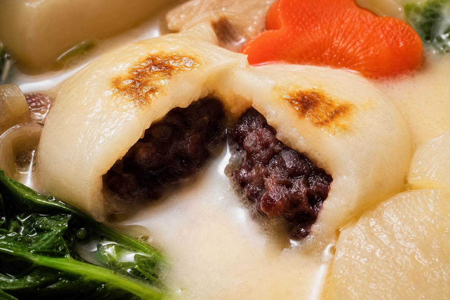 Close-up of an-mochi cut open to reveal the red-bean paste inside