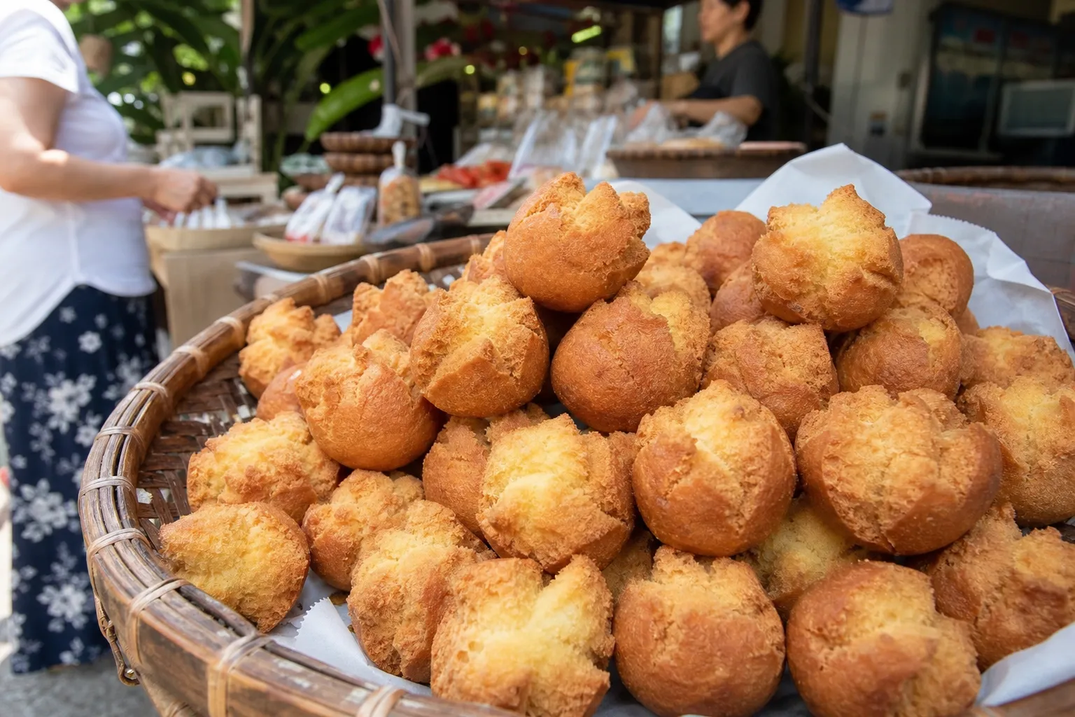 A basket of golden sata andagi at an Okinawan market snack stall