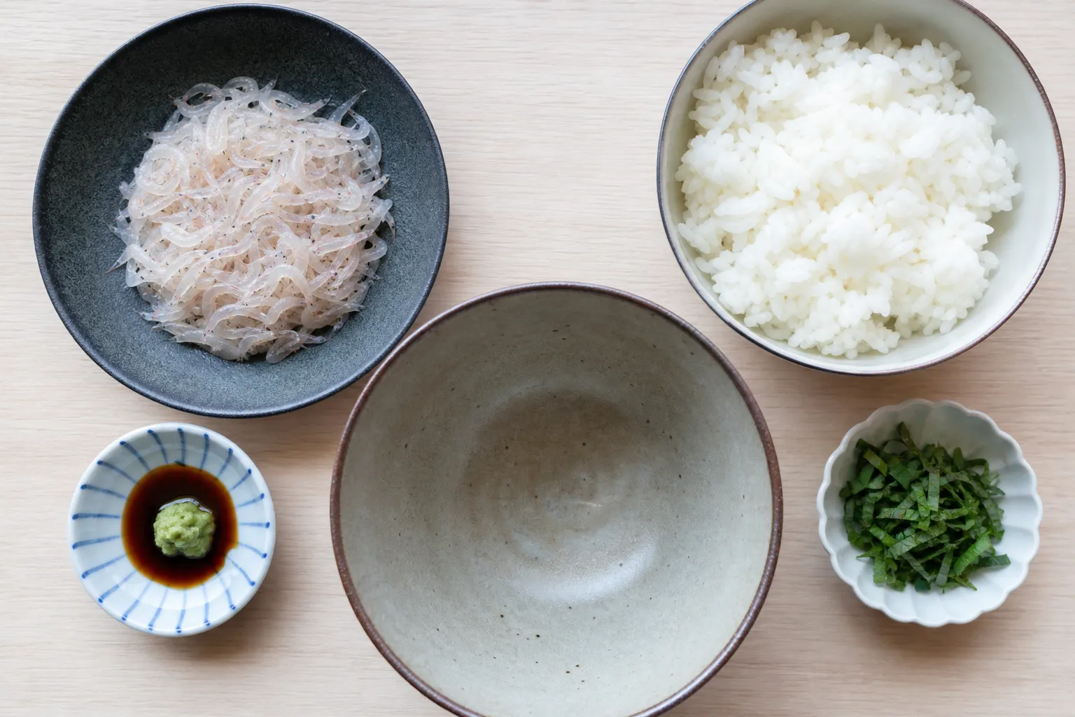 Raw shiro-ebi, steamed rice, wasabi, soy and shiso laid out separately
