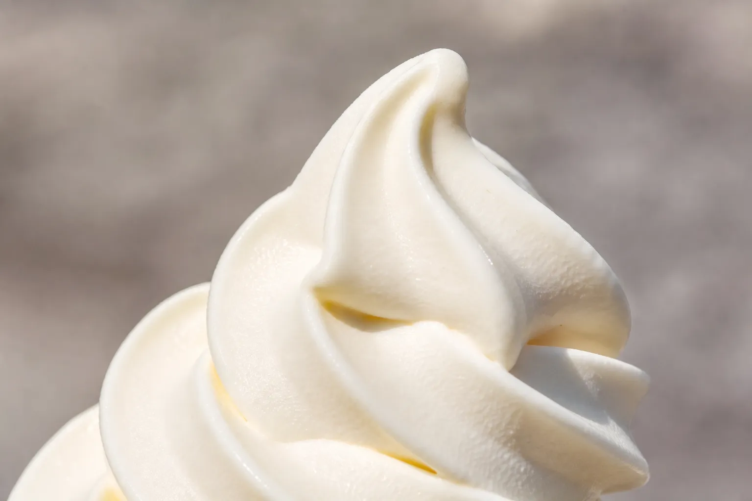 Close-up of the swirl ridges of a Japanese soft-serve ice cream showing its silky creamy texture