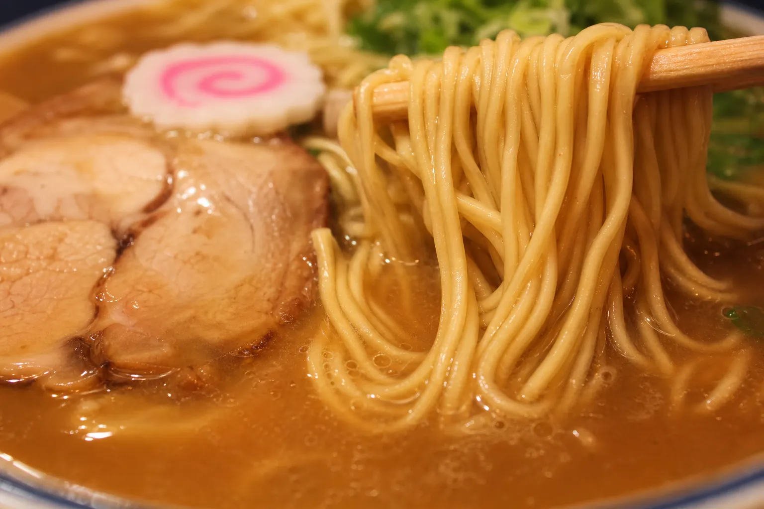 Close-up of Wakayama ramen broth and thin straight noodles